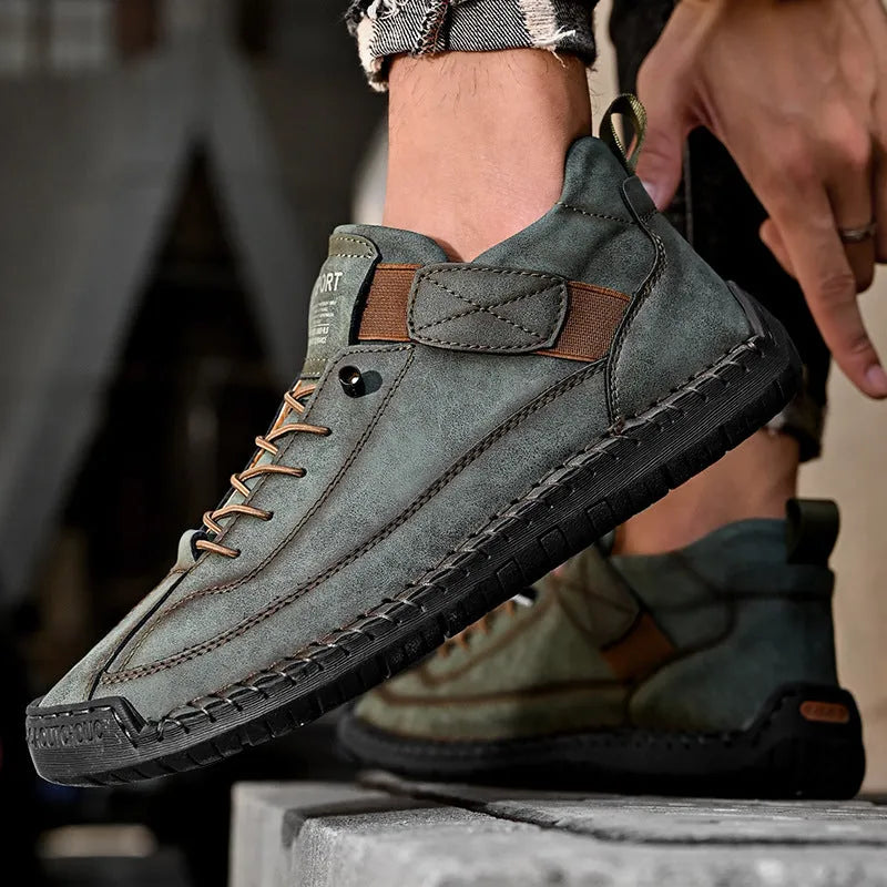 Men's mid-top Martin boot in khaki with tooling stitching and an elastic band ankle closure.