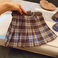 Girls red and black plaid pleated A-line skirt on a hanger.