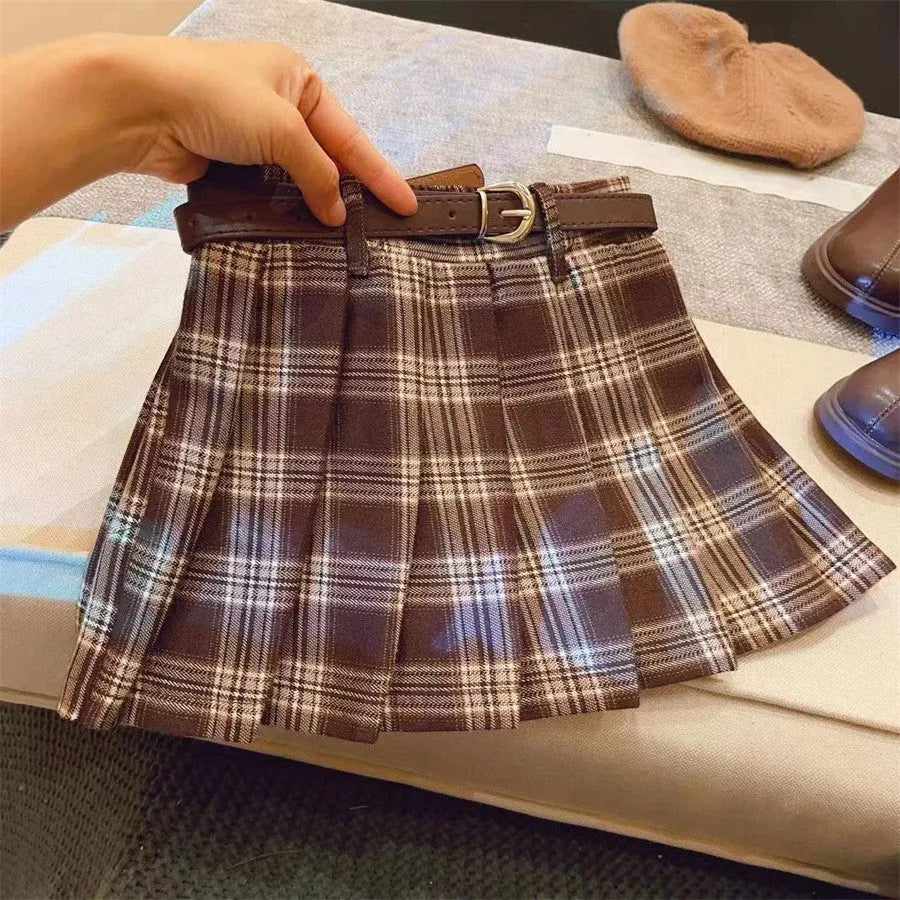 Girls red and black plaid pleated A-line skirt on a hanger.