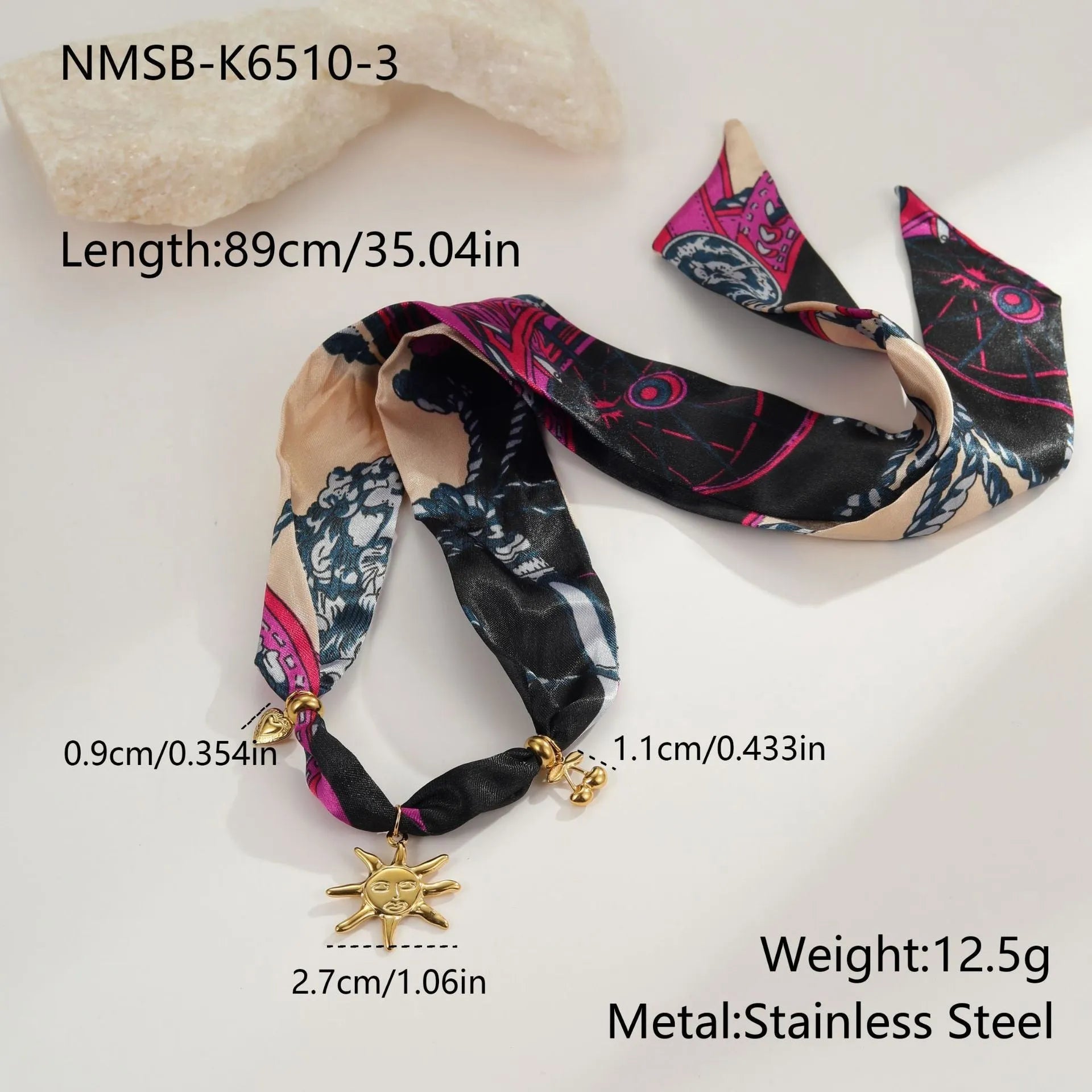 Geometric pendant on a gold chain, shown as a women's necklace or bracelet against an autumn backdrop.