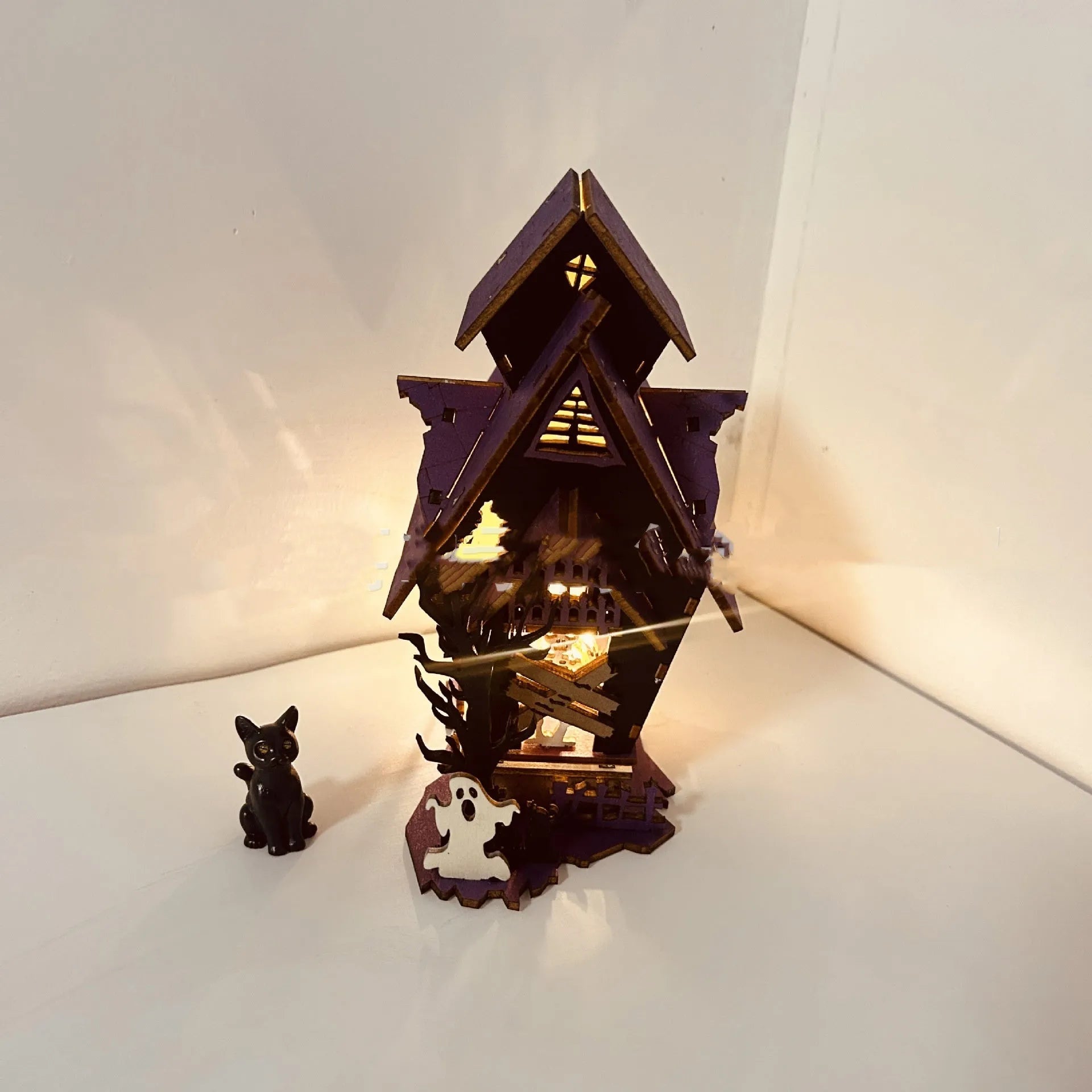 Wooden glowing haunted house Halloween table decoration with candlestick holder, 14cm wide.