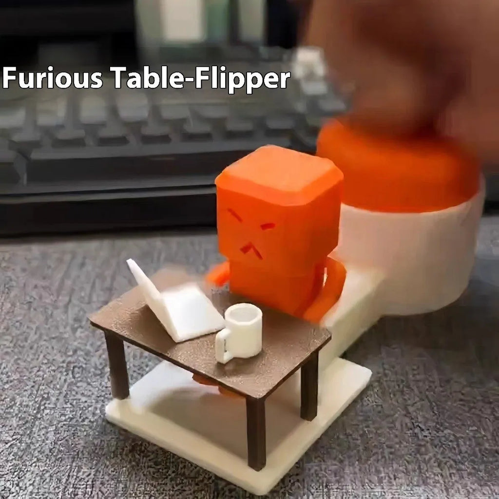 Orange plastic table turning decompression toy measuring 16cm long on a desk
