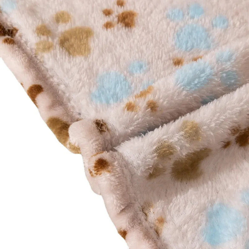 Blue cartoon dog pattern double-sided flannel pet blanket shown on a dog bed.