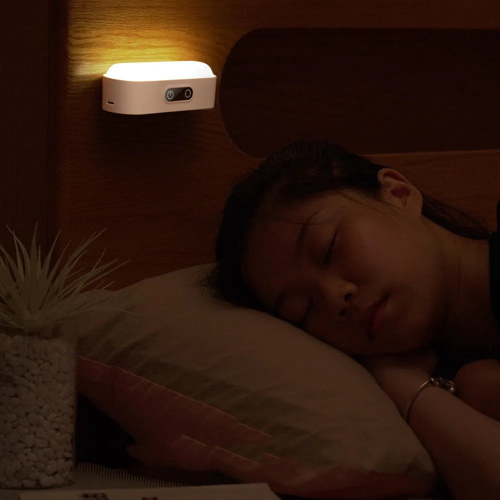 White magnetic USB rechargeable LED night light with touch controls and a curved light surface.