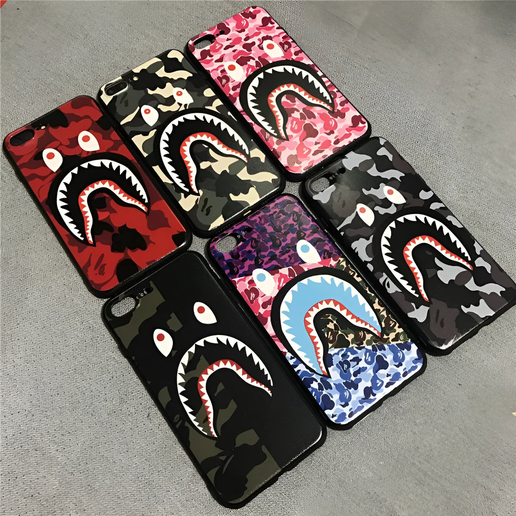 Frosted silicone phone case with shark mouth design in red, green, gray, and pink colours
