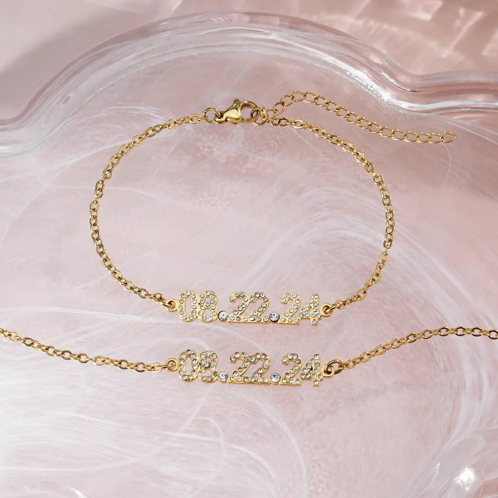 Stainless steel digital bracelet and necklace with diamond-set numbers in gold, rose gold, or steel colour.