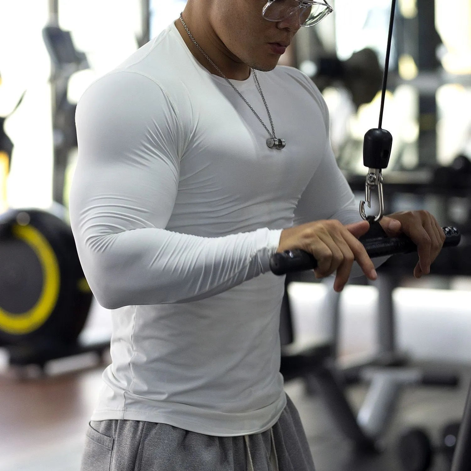 Men's black slim-fit fitness tights with long sleeves for running or gym workouts