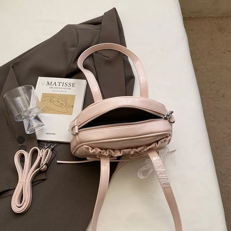 Casual ladies shoulder handbag with bandage bow detail in PU material showing mobile phone compartment