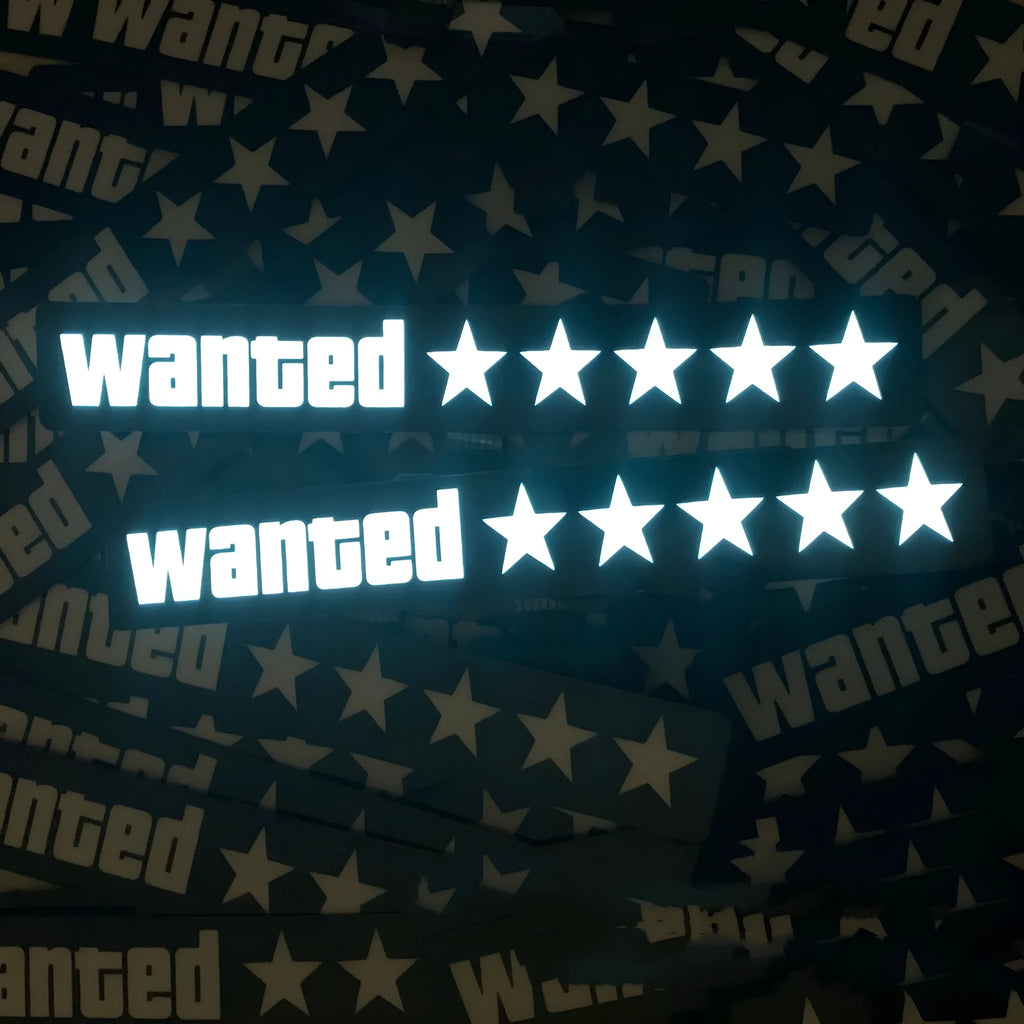 White luminous car sticker in Wanted design, 27cm long and 0.35mm thick, mounted on a car dashboard