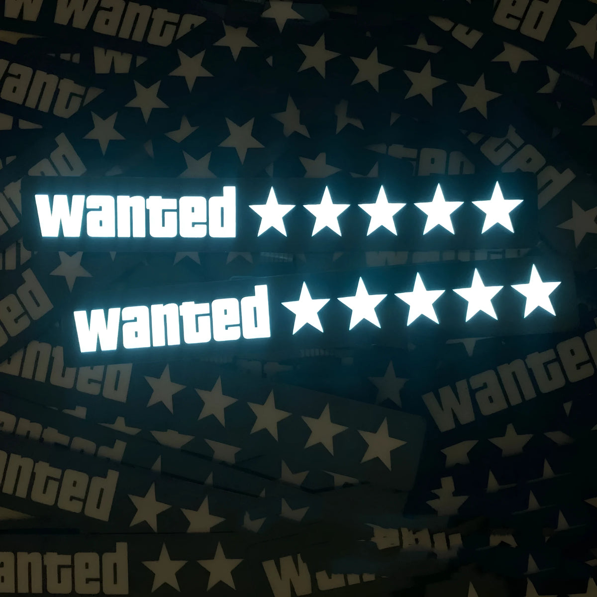 White luminous car sticker in Wanted design, 27cm long and 0.35mm thick, mounted on a car dashboard