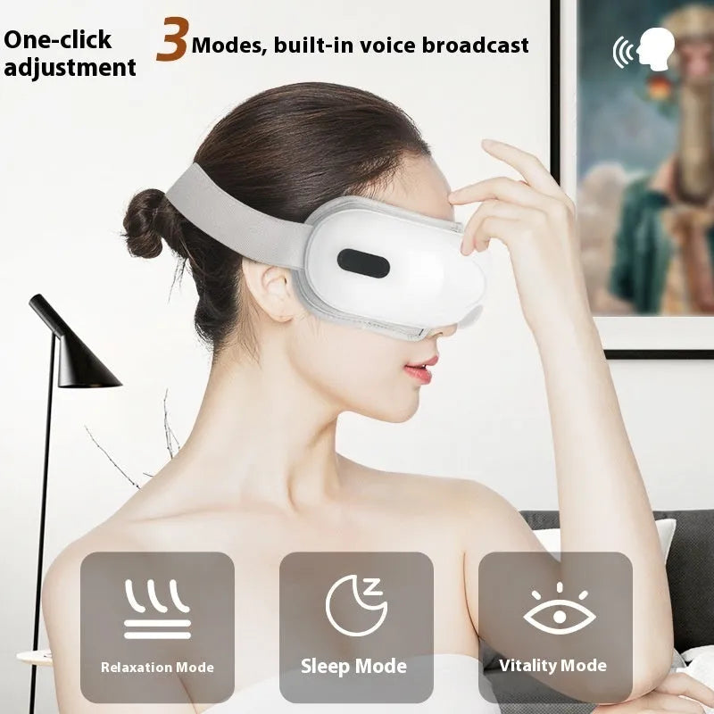 White rechargeable eye massager with airbag massage and hot compress functions on a table