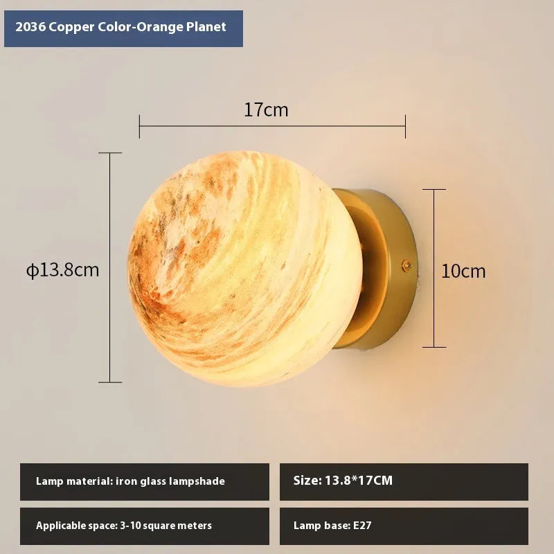 Planet Aisle bedside lamp with painted glass shade in black blue planet colour, on a table