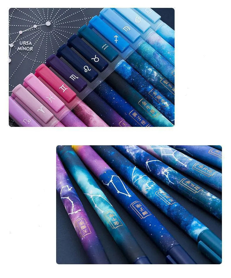 Twelve constellation ballpoint pens with zodiac designs on a light background