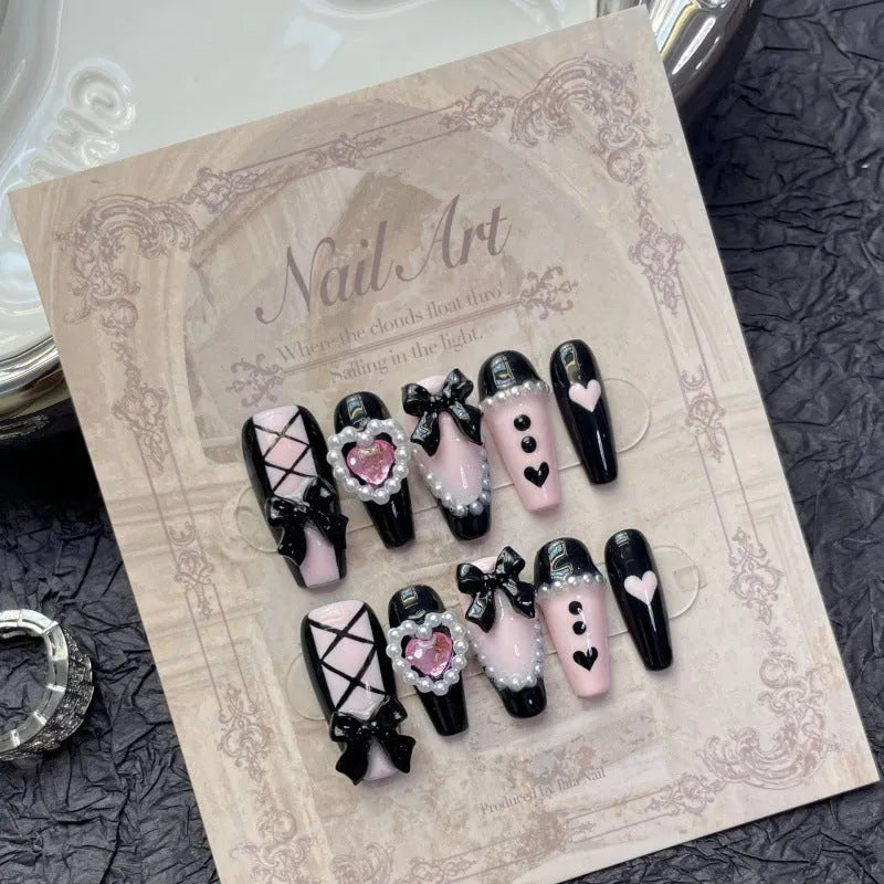 Hand-painted black peach heart artificial nails with bow design in four sizes
