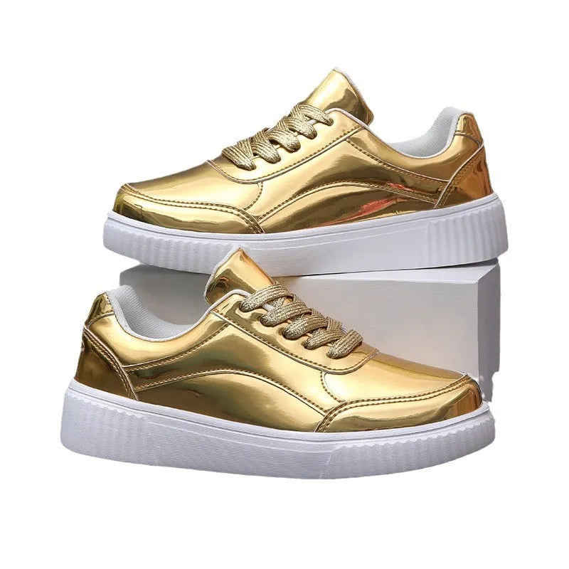 Gold sequinned platform sneakers with round toe and thick MD sole on white background.